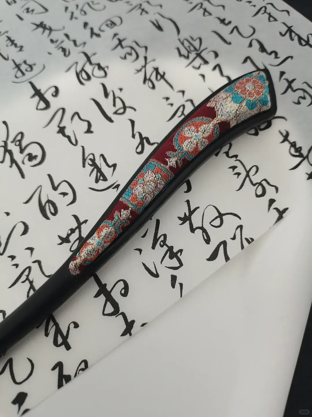 深色木簪中的绛红宋锦花叶纹样